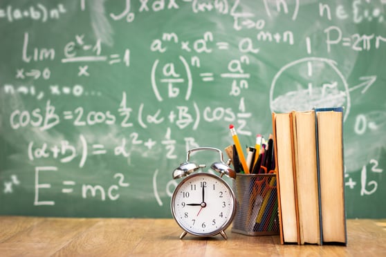 chalkboard background with clock and books in foreground