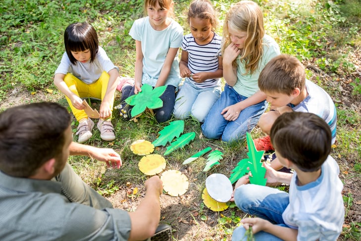 Students outside learning about the shapes of leaves