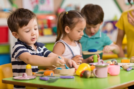 A group of preschool students playing with various toys