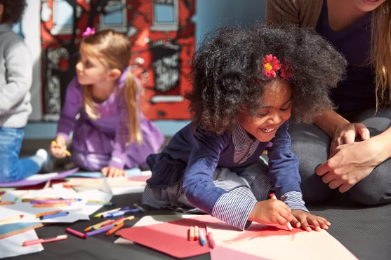 Preschooler smiling and coloring