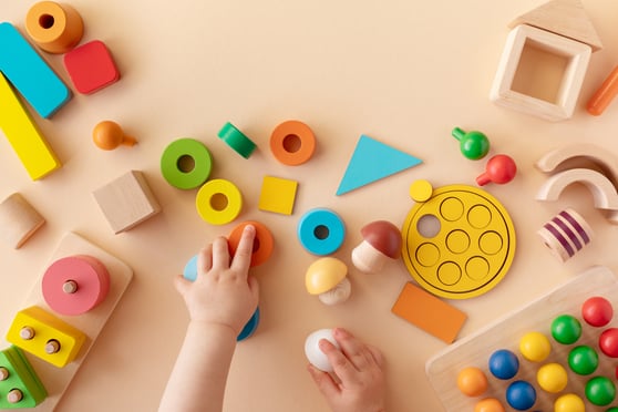 Young student playing with blocks and shapes
