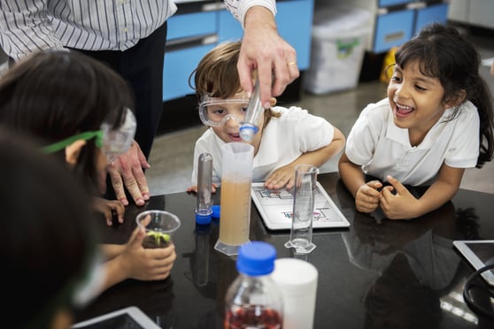 kindergarteners participate in science experiments.