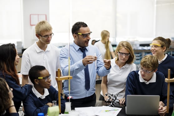 STEM teacher instructing high school students